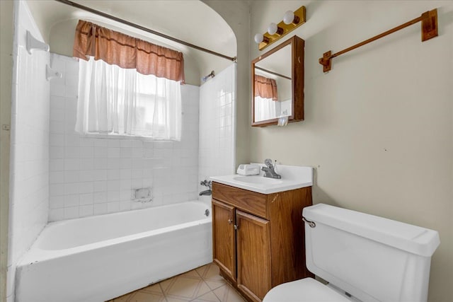 bathroom featuring toilet, tile patterned floors, washtub / shower combination, and vanity