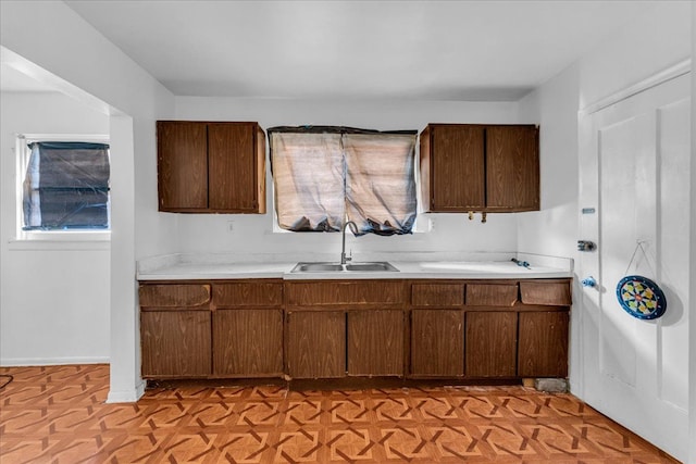 kitchen with a healthy amount of sunlight, light countertops, and a sink