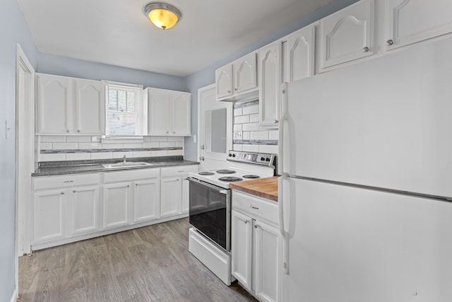 kitchen featuring backsplash, light wood-type flooring, white appliances, white cabinetry, and a sink