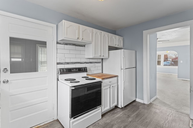 kitchen with decorative backsplash, white appliances, dark wood-style floors, and white cabinetry