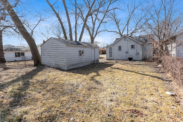 view of yard featuring an outdoor structure and fence