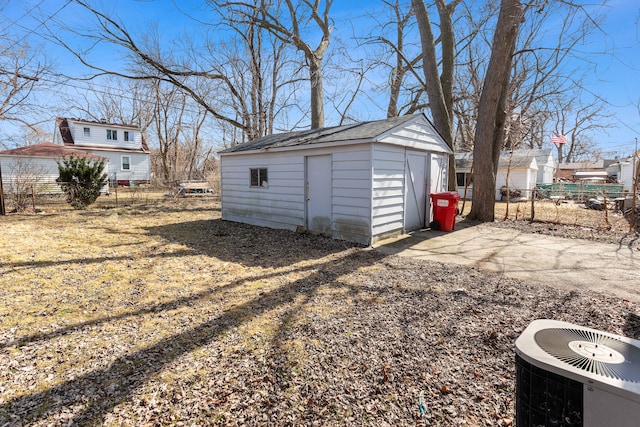 exterior space featuring cooling unit, an outdoor structure, and fence