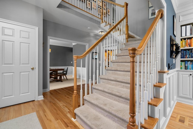 stairs with visible vents, baseboards, and wood finished floors