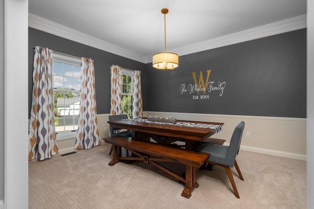 carpeted dining room featuring visible vents, ornamental molding, and baseboards