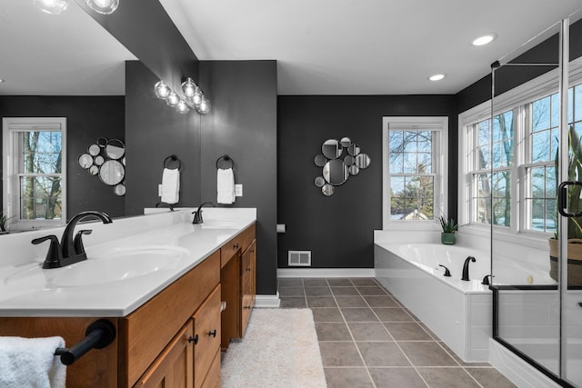 full bathroom featuring visible vents, a sink, a bath, baseboards, and tile patterned floors