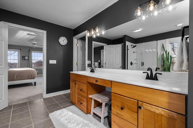 full bath featuring a shower, tile patterned flooring, a sink, and double vanity