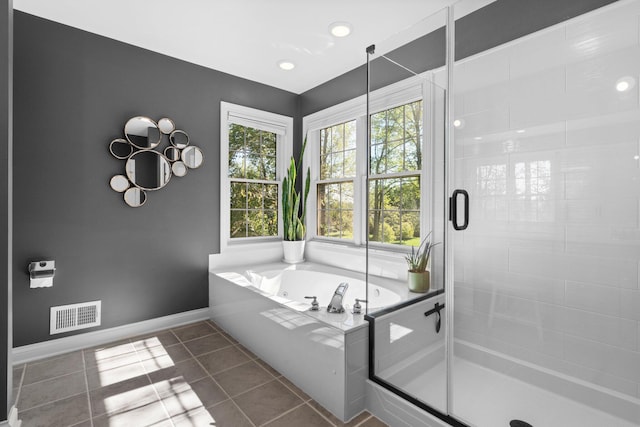 full bathroom featuring a stall shower, baseboards, visible vents, tile patterned floors, and a bath