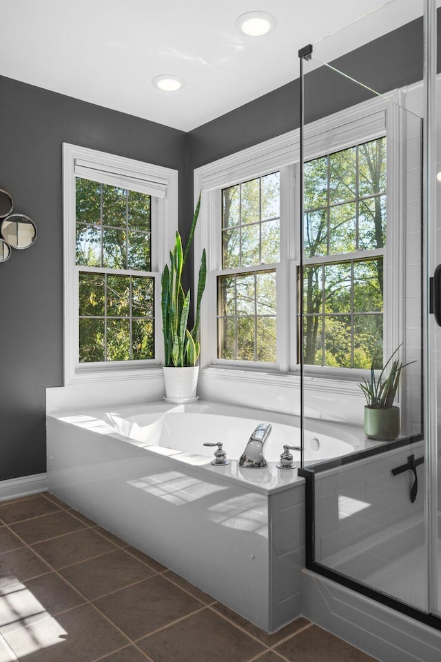 full bath featuring tile patterned flooring and a bath