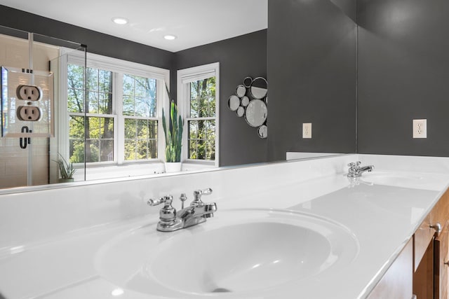 full bathroom featuring double vanity and a sink