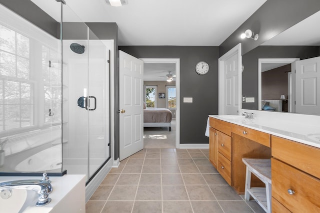 ensuite bathroom featuring connected bathroom, vanity, and a shower stall