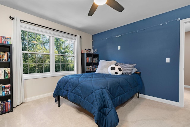 bedroom featuring carpet, baseboards, and a ceiling fan