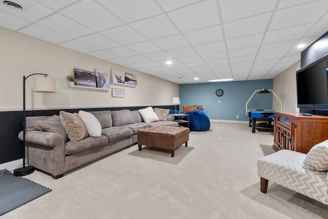 living room featuring carpet floors, a drop ceiling, visible vents, and baseboards