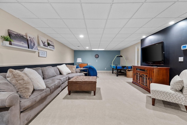 carpeted living room featuring a paneled ceiling, baseboards, and recessed lighting