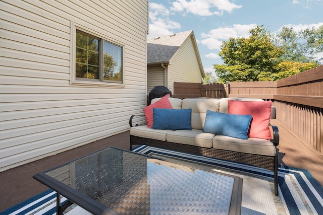 wooden terrace featuring fence and outdoor lounge area