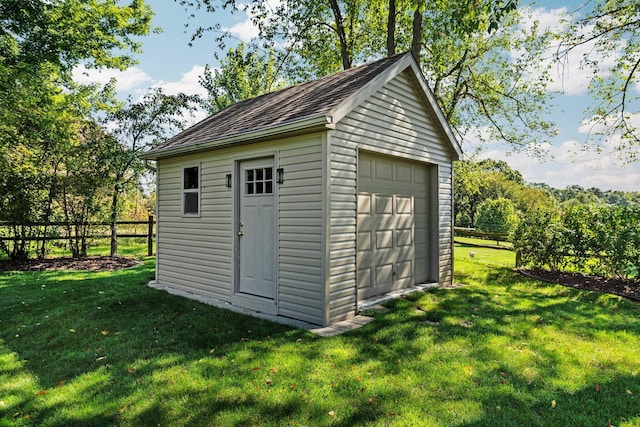 view of outdoor structure featuring an outbuilding and fence