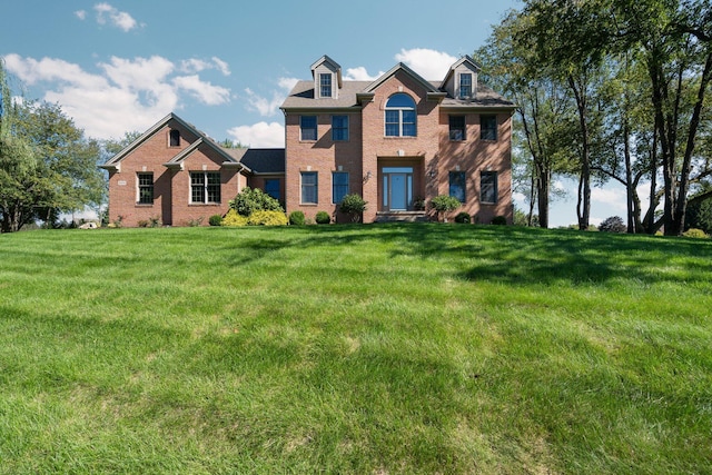 view of front of property with brick siding and a front yard