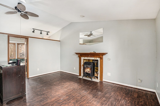 unfurnished living room with wood finished floors, a ceiling fan, baseboards, vaulted ceiling, and track lighting