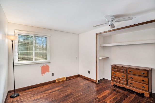 bedroom featuring a ceiling fan, visible vents, baseboards, a closet, and dark wood finished floors