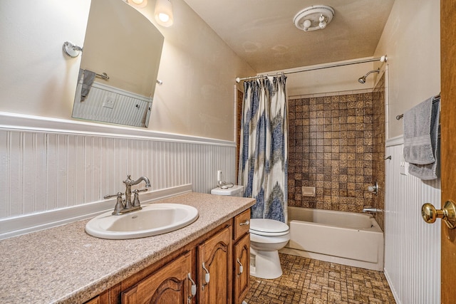 full bath with shower / bath combination with curtain, wainscoting, vanity, and toilet