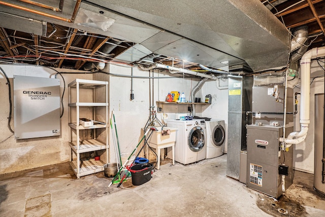 unfinished below grade area featuring a sink, heating unit, and washer and dryer