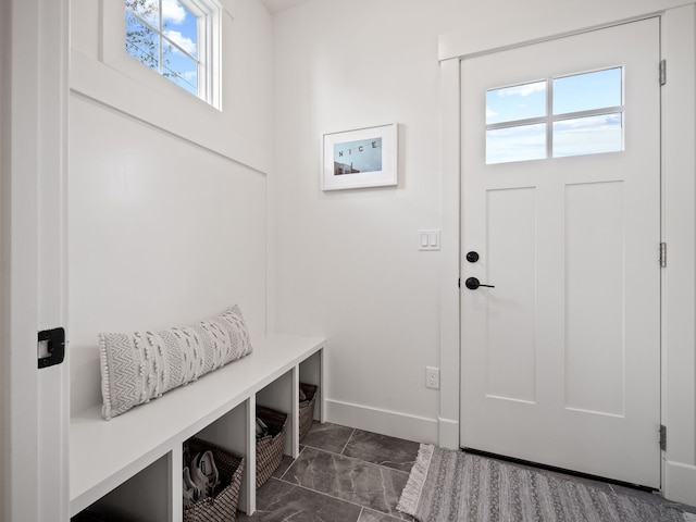 mudroom featuring plenty of natural light and baseboards