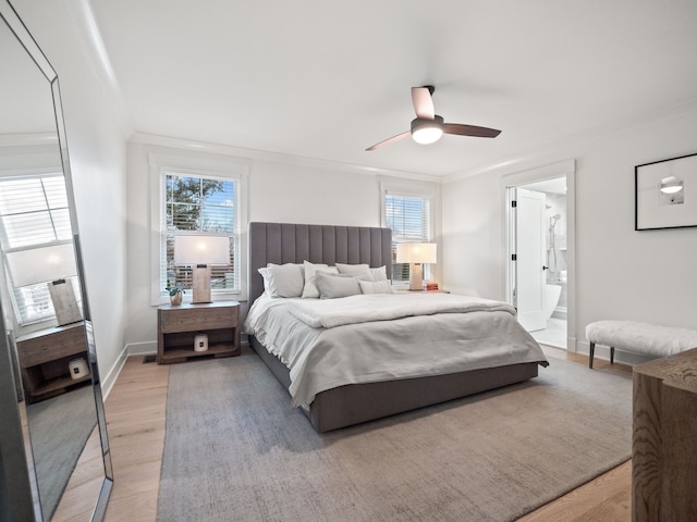 bedroom with ornamental molding, a ceiling fan, connected bathroom, light wood-style floors, and baseboards