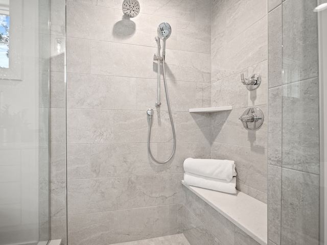 bathroom with a tile shower