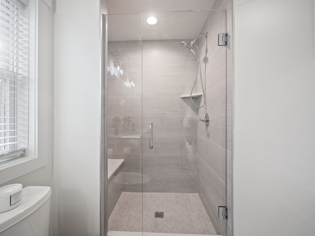 full bathroom with toilet and a shower stall