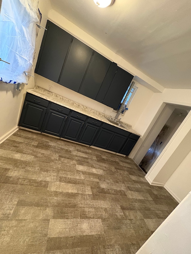 interior space with baseboards and wood finished floors