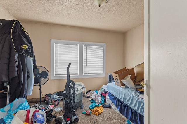 bedroom with carpet floors and a textured ceiling