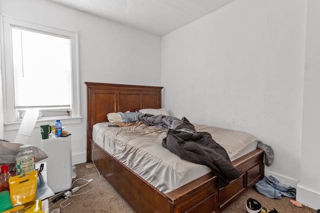 bedroom with baseboards and carpet floors