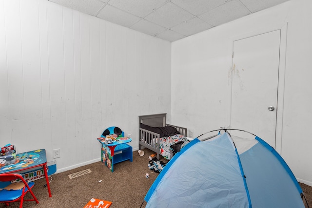 bedroom featuring visible vents, a paneled ceiling, baseboards, and carpet floors