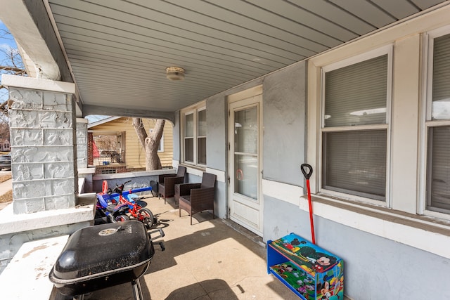 view of patio with a porch and a grill