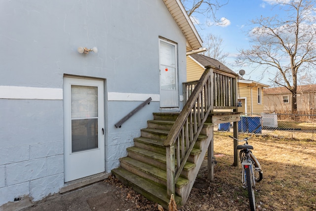 entrance to property featuring fence