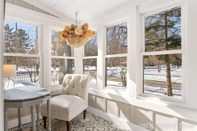 sunroom / solarium featuring vaulted ceiling