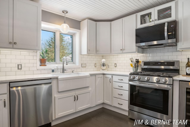 kitchen with backsplash, dark wood-style flooring, appliances with stainless steel finishes, and wine cooler