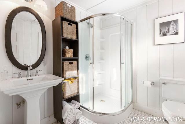 bathroom with a sink, tile patterned floors, a shower stall, and toilet