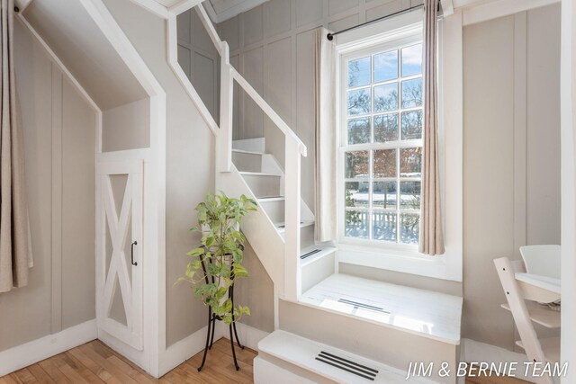interior space featuring baseboards, a wealth of natural light, and wood finished floors