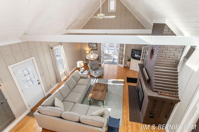 living area featuring vaulted ceiling, wood finished floors, and a wealth of natural light