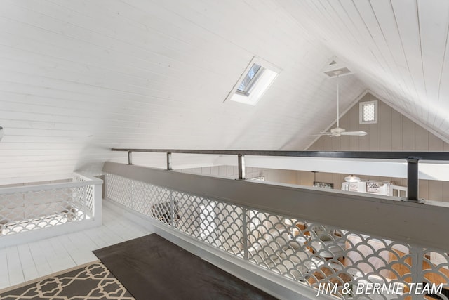 interior space with wooden walls and a skylight