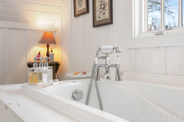 interior details with a bathing tub and toilet