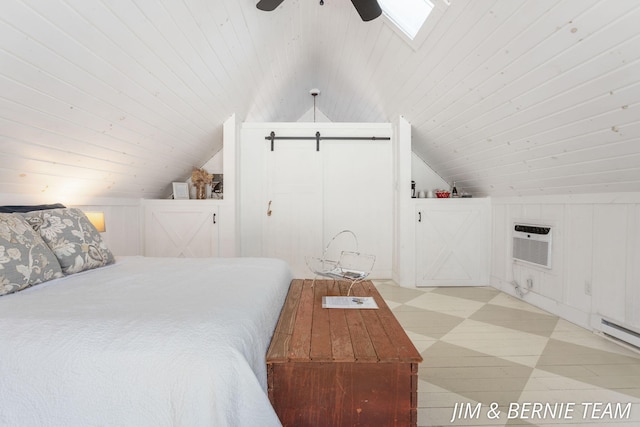 bedroom featuring wood ceiling, ceiling fan, vaulted ceiling, a barn door, and a wall mounted air conditioner