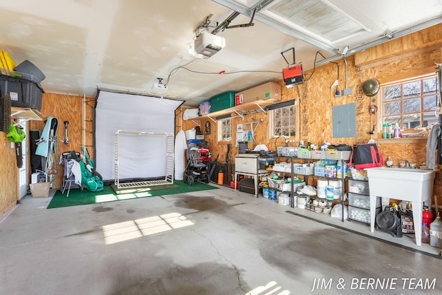 garage featuring wooden walls, a garage door opener, and electric panel