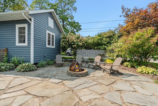 view of patio / terrace featuring fence and a fire pit