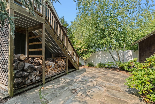 view of patio / terrace with fence and stairway