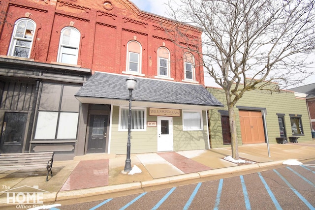 view of building exterior with uncovered parking