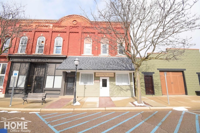 view of property featuring uncovered parking