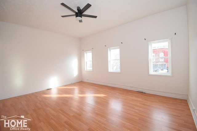 spare room with light wood-style flooring, baseboards, and ceiling fan