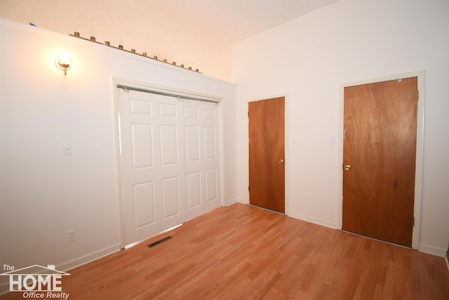 unfurnished bedroom featuring light wood-type flooring, visible vents, and baseboards