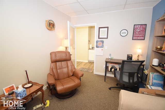 office space featuring carpet floors, a paneled ceiling, and baseboards